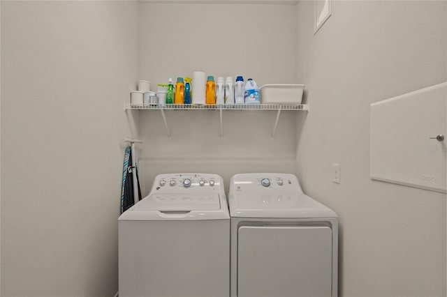 clothes washing area featuring washer and dryer