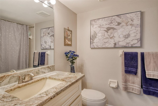 bathroom featuring vanity, toilet, and a shower with shower curtain