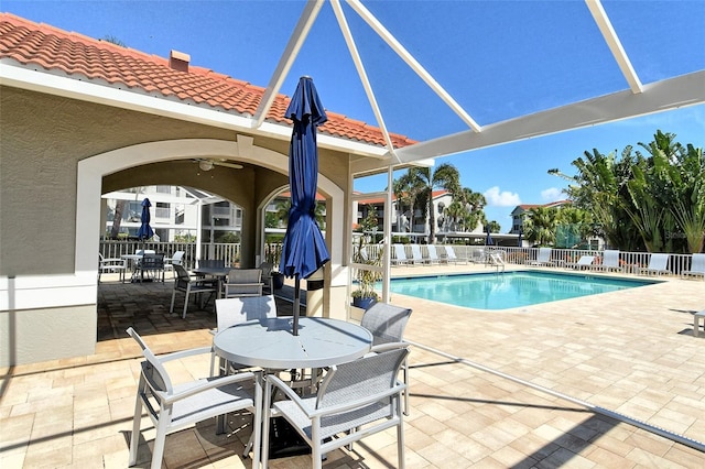 view of pool with ceiling fan and a patio