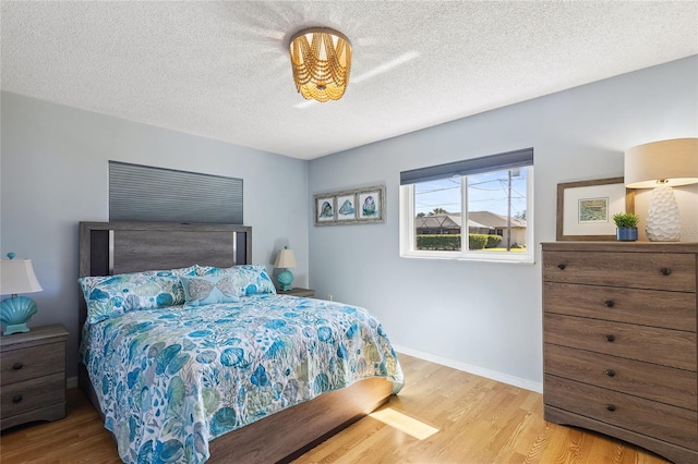 bedroom with hardwood / wood-style flooring and a textured ceiling