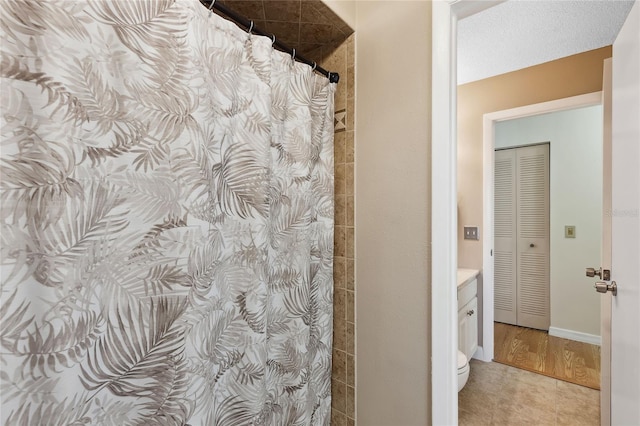 bathroom with vanity, walk in shower, and toilet