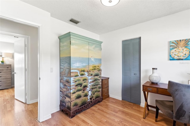 office space with hardwood / wood-style floors and a textured ceiling