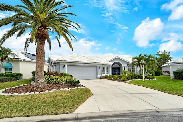 ranch-style home with a garage and a front lawn