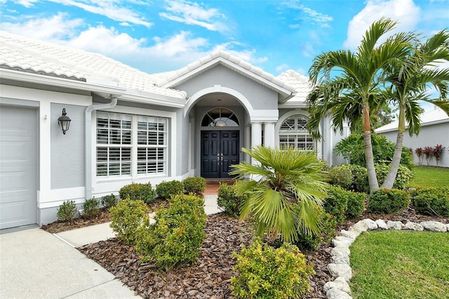 doorway to property with a garage