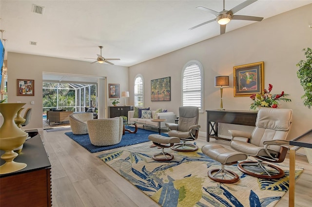 living room with ceiling fan and light wood-type flooring