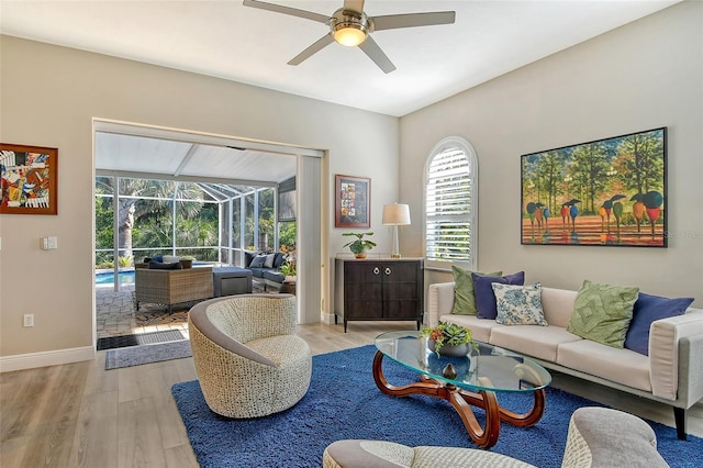 living room with ceiling fan and light wood-type flooring