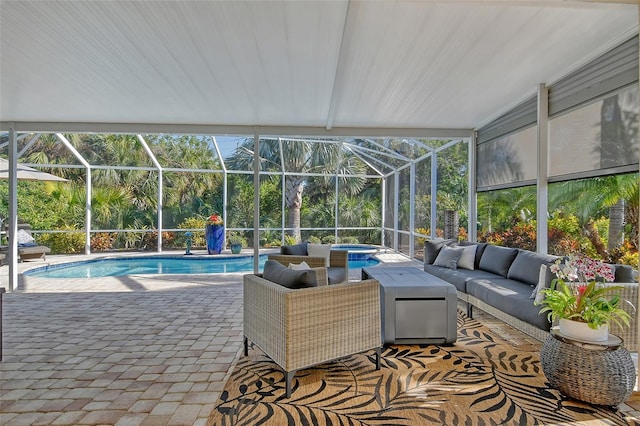 view of swimming pool featuring a patio, outdoor lounge area, an in ground hot tub, and glass enclosure