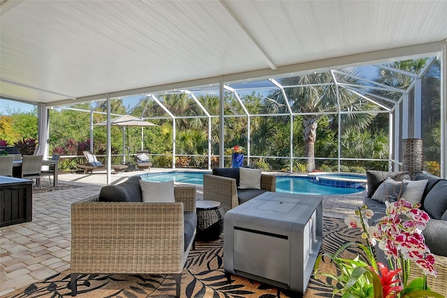 view of patio / terrace with an outdoor living space, a pool with hot tub, and glass enclosure