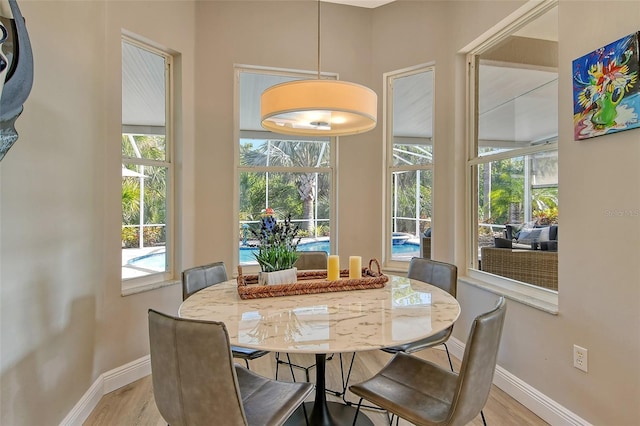 dining area with plenty of natural light and light wood-type flooring