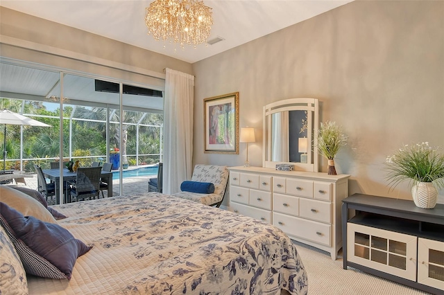 carpeted bedroom featuring access to outside and a notable chandelier