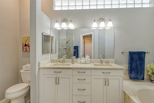 full bathroom featuring vanity, shower with separate bathtub, and toilet