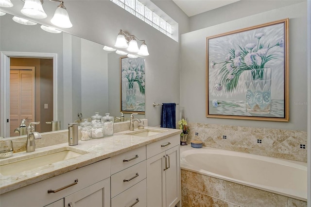 bathroom with vanity and a relaxing tiled tub