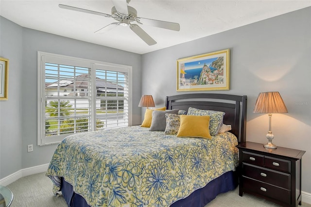 bedroom featuring light carpet and ceiling fan