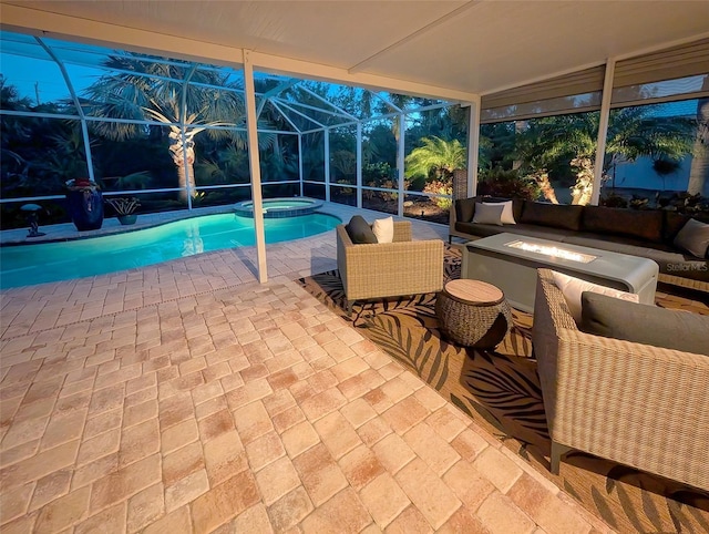 pool at dusk with an outdoor living space, a lanai, a patio area, and an in ground hot tub