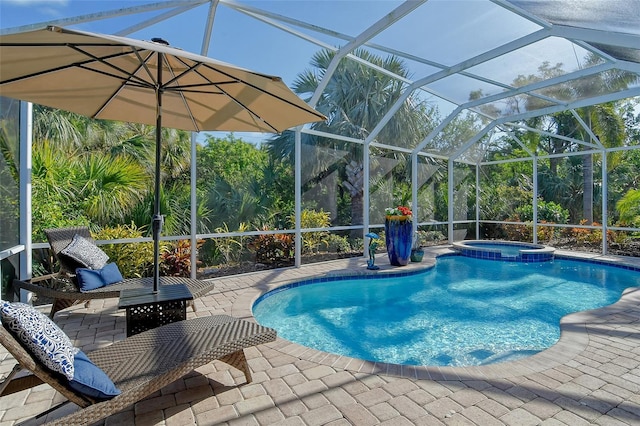 view of pool featuring an in ground hot tub, a patio area, and glass enclosure