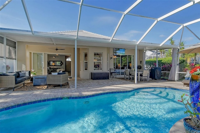 view of pool with a lanai, ceiling fan, a grill, an outdoor hangout area, and a patio