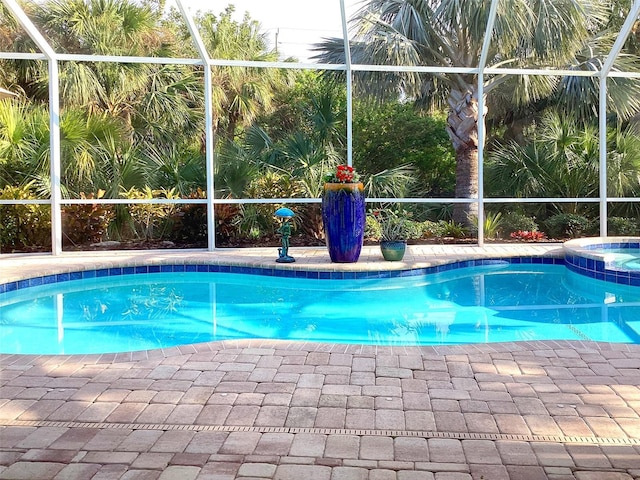 view of pool with a lanai and central AC unit