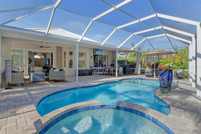 view of swimming pool featuring an outdoor living space, ceiling fan, glass enclosure, and a patio