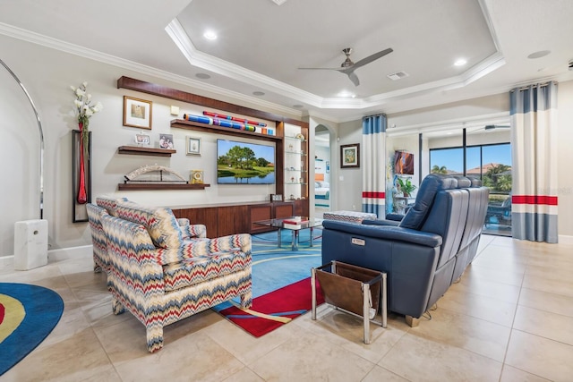 living room with crown molding, a raised ceiling, ceiling fan, and light tile patterned flooring