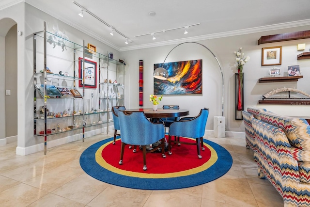 tiled dining space with ornamental molding and rail lighting