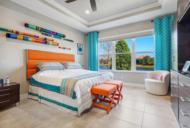 tiled bedroom featuring crown molding, ceiling fan, and a tray ceiling