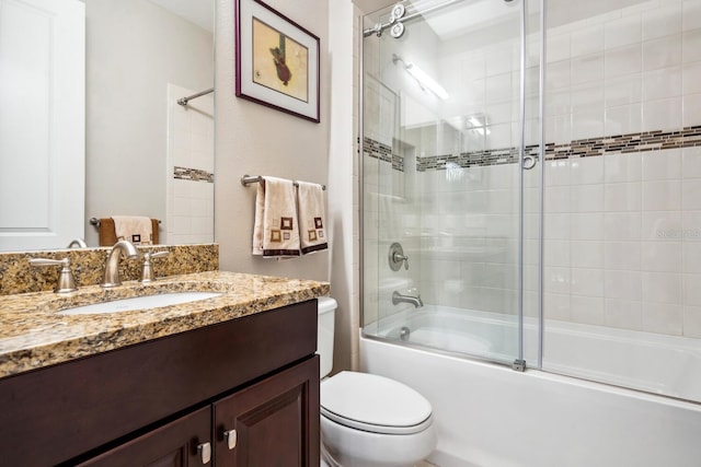 full bathroom featuring vanity, toilet, and combined bath / shower with glass door