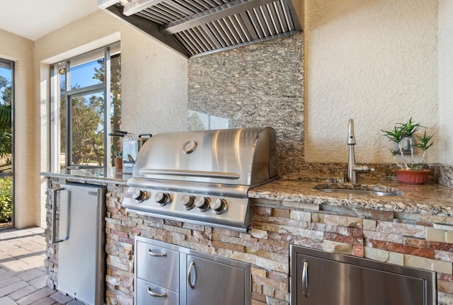 view of patio featuring area for grilling and sink