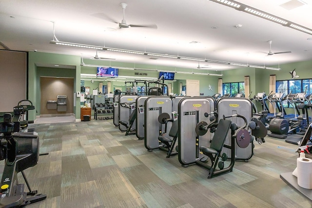 exercise room featuring light colored carpet and ceiling fan