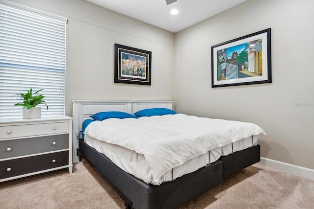 bedroom featuring recessed lighting, light carpet, and baseboards