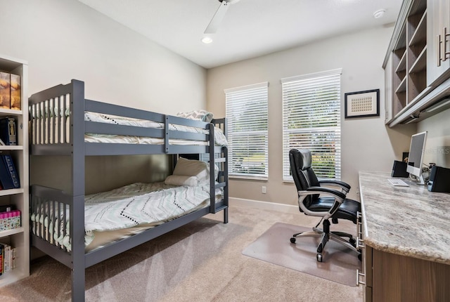 bedroom with light carpet, ceiling fan, and baseboards