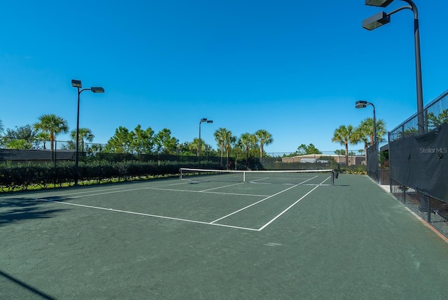 view of tennis court with fence