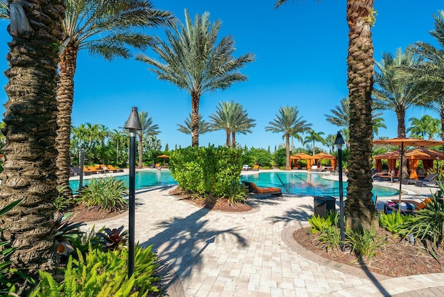 community pool with a patio area and a gazebo