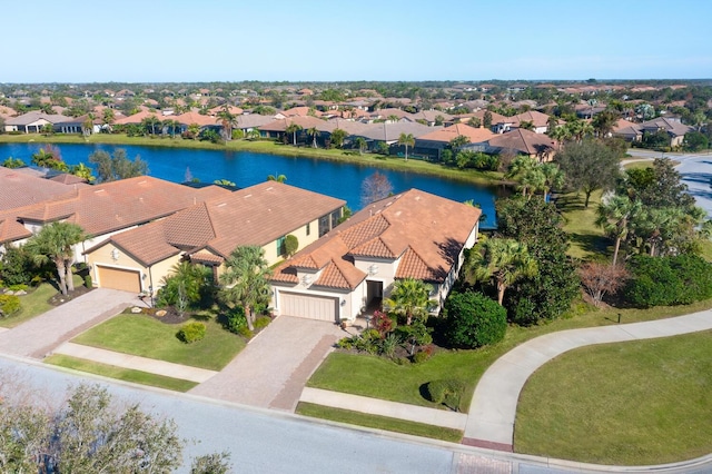 drone / aerial view with a water view and a residential view