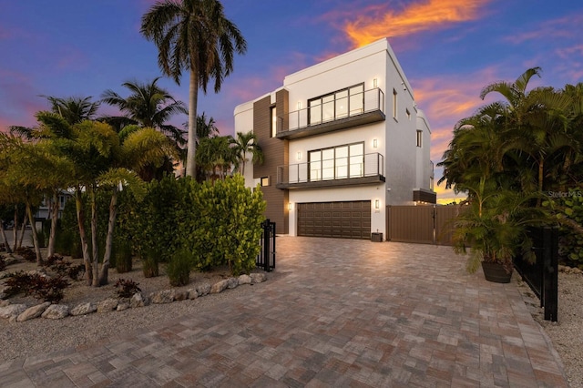 view of front facade featuring a garage and a balcony