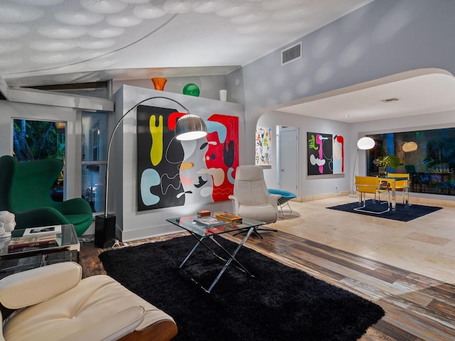 playroom featuring lofted ceiling, baseboards, visible vents, and wood finished floors