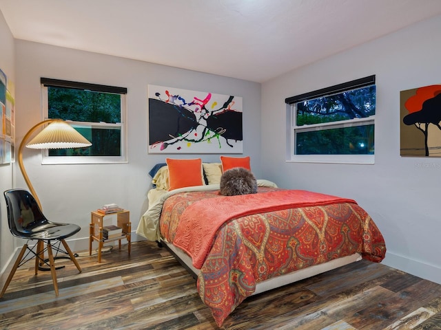 bedroom with baseboards and wood finished floors