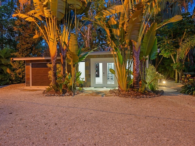 view of front of property featuring driveway and french doors