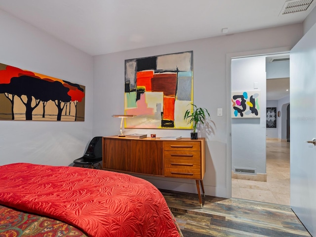 bedroom featuring arched walkways and visible vents