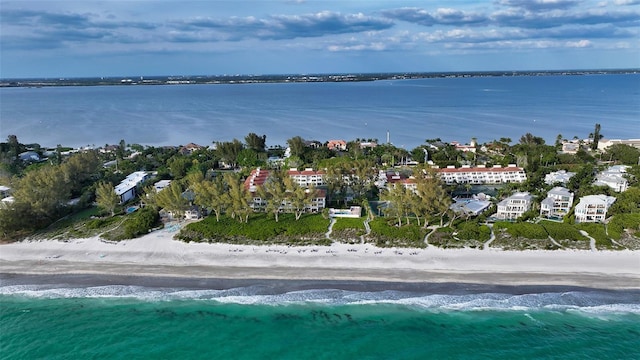 birds eye view of property featuring a beach view and a water view