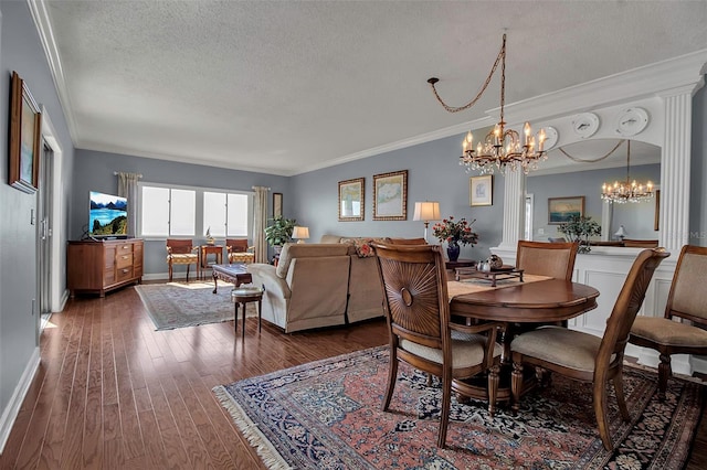 dining area with crown molding, a textured ceiling, baseboards, and wood finished floors