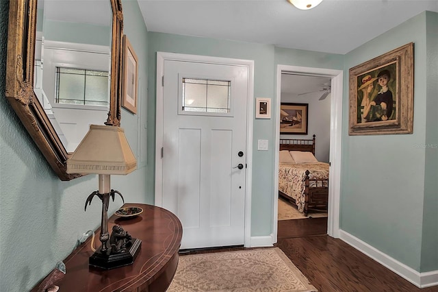 entryway featuring dark wood-style floors and baseboards