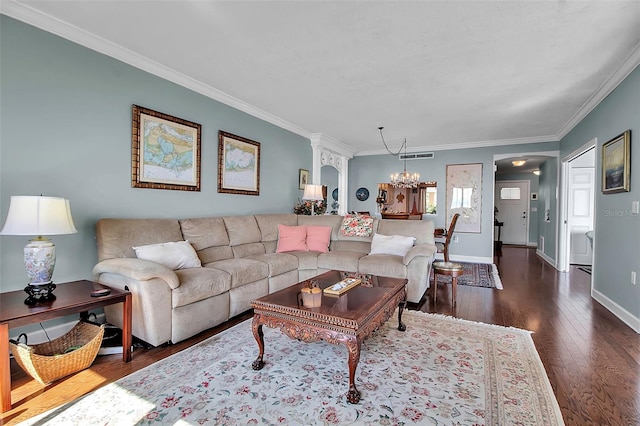 living area with crown molding, wood-type flooring, visible vents, and baseboards