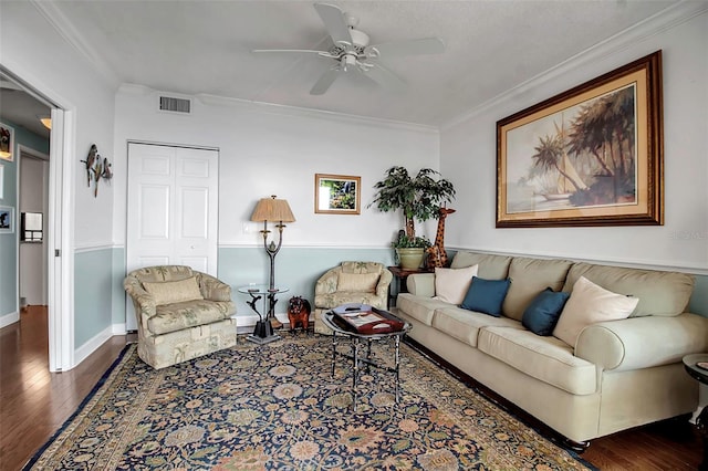 living area with dark wood-style floors, visible vents, crown molding, and ceiling fan