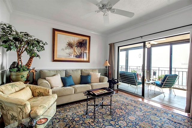 living area featuring a ceiling fan, crown molding, a textured ceiling, and wood finished floors