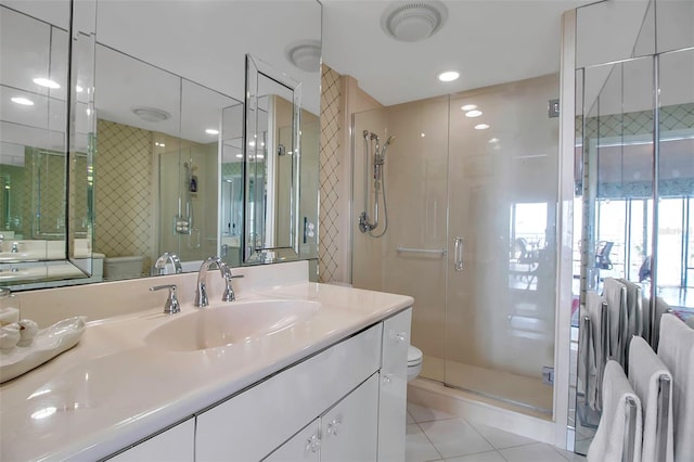 bathroom featuring toilet, a stall shower, and vanity