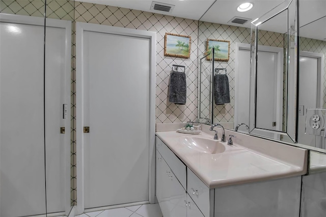 bathroom with vanity, visible vents, and recessed lighting