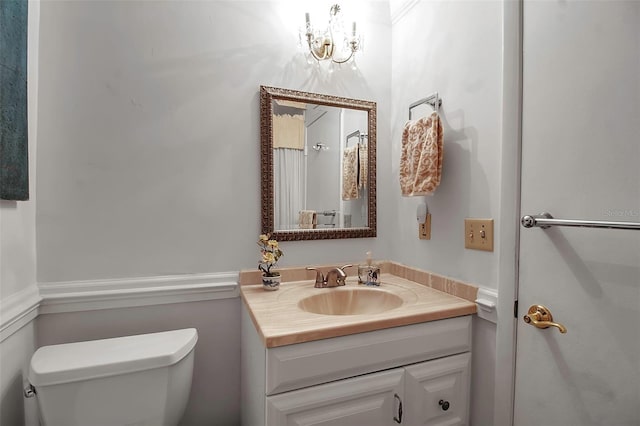 bathroom with toilet and vanity