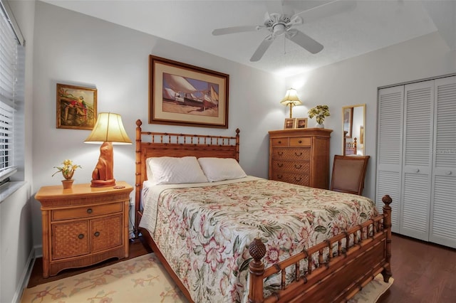 bedroom with ceiling fan, a closet, wood finished floors, and baseboards