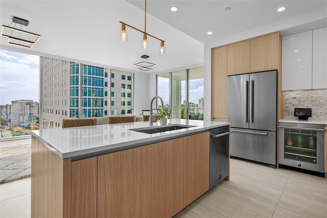 kitchen featuring modern cabinets, wine cooler, high end fridge, a view of city, and a sink