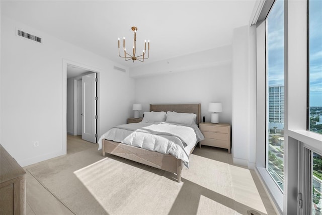 bedroom featuring baseboards, expansive windows, visible vents, and a chandelier